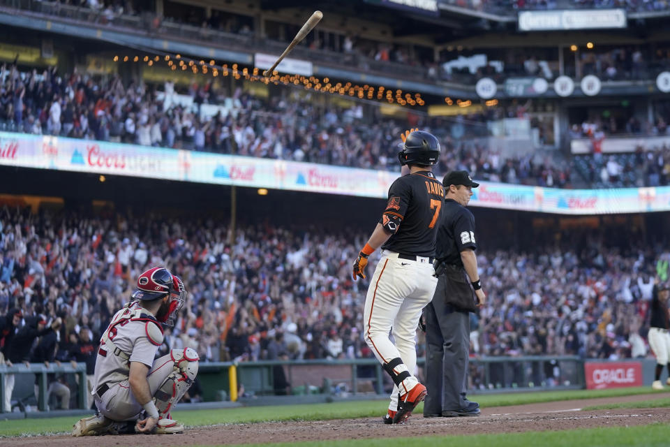 San Francisco Giants' J.D. Davis (7) tosses his bat after hitting the winning home run next to Boston Red Sox catcher Connor Wong, left, during the ninth inning of a baseball game in San Francisco, Saturday, July 29, 2023. (AP Photo/Jeff Chiu)