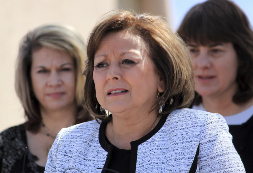 New Mexico Gov. Susana Martinez is flanked by advocates as she talks about opioid and heroin overdoses in New Mexico during a bill signing ceremony at a substance abuse treatment center in Albuquerque, N.M., on Thursday, April 6, 2017. Among other things, the bill signed by Martinez requires all state and local law enforcement officers to be equipped with an overdose antidote kit. (AP Photo/Susan Montoya Bryan)