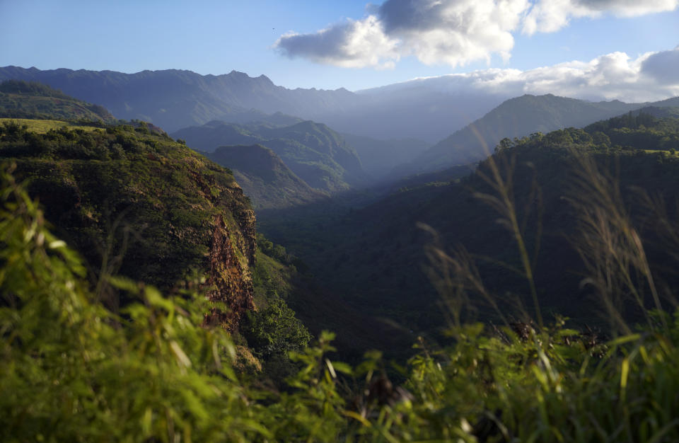 The sun shines over the Hanapepe Valley in Hawaii on Friday, July 14, 2023. (AP Photo/Jessie Wardarski)