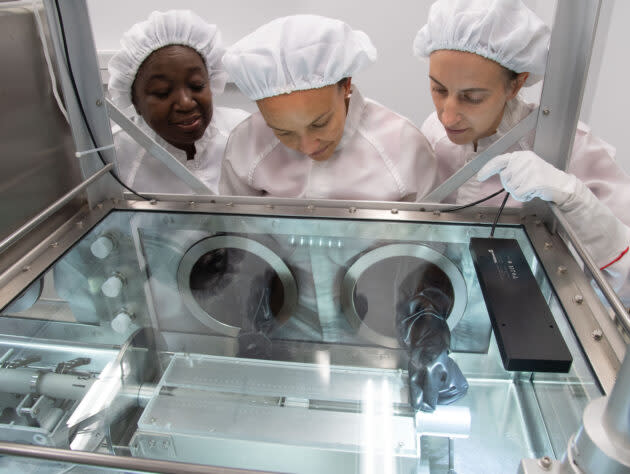 Apollo sample processors Andrea Mosie, Charis Krysher and Juliane Gross open lunar sample 73002 at NASA’s Johnson Space Center in Houston. (NASA Photo / James Blair)