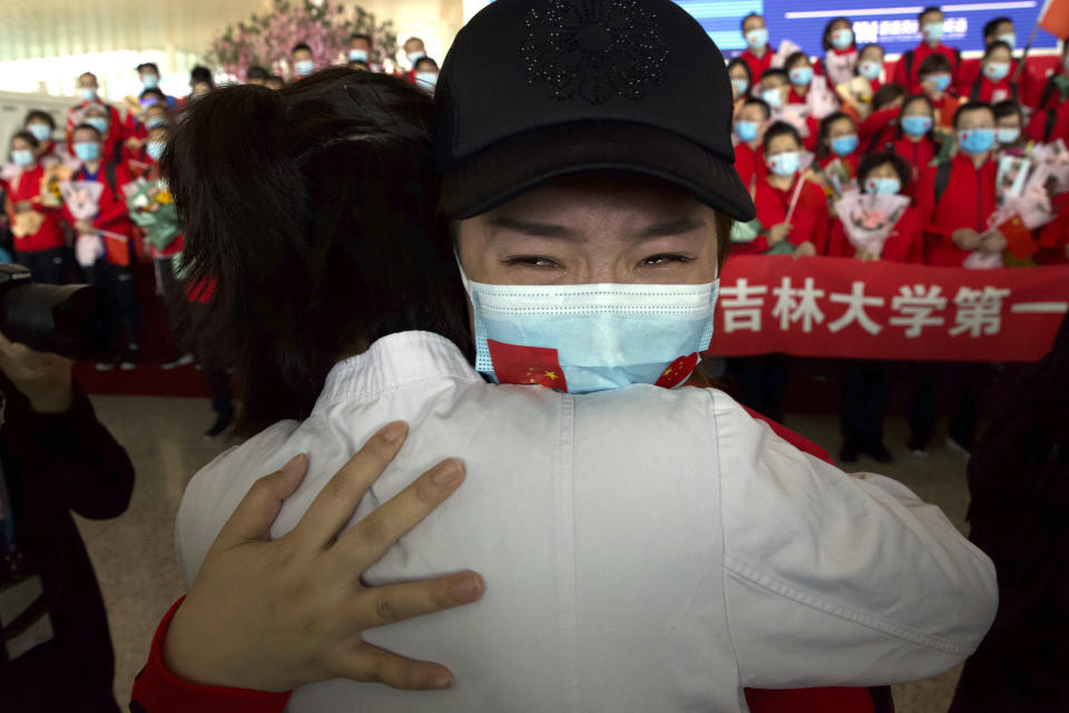 A medical worker from Jilin Province reacts as she prepares to return home at Wuhan Tianhe International Airport.