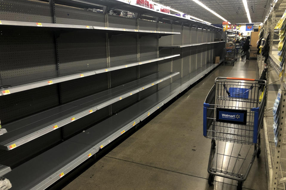 This photo shows the toilet paper aisle with empty shelves at Walmart on Friday, March 13, 2020, in San Leandro, Calif. Officials said Friday the Los Angeles Unified School District and San Diego school districts will close starting March 16 because of the coronavirus threat.(AP Photo/Ben Margot)