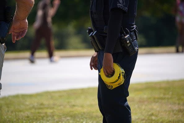 WINDER, GEORGIA - SEPTEMBER 4: A law enforcement officer holds a roll of caution tape after a shooting at Apalachee High School on September 4, 2024 in Winder, Georgia. Multiple fatalities and injuries have been reported and a suspect is in custody according to authorities.(Photo by Megan Varner/Getty Images)