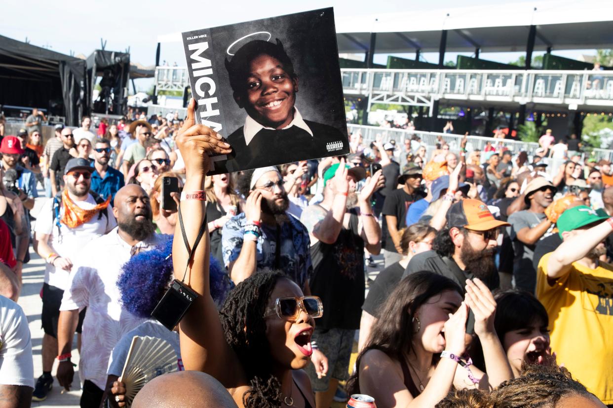 A fan holds up a Killer Mike album and cheers as he performs at RiverBeat Music Festival on Saturday, May 4, 2024, at Tom Lee Park in Downtown Memphis.