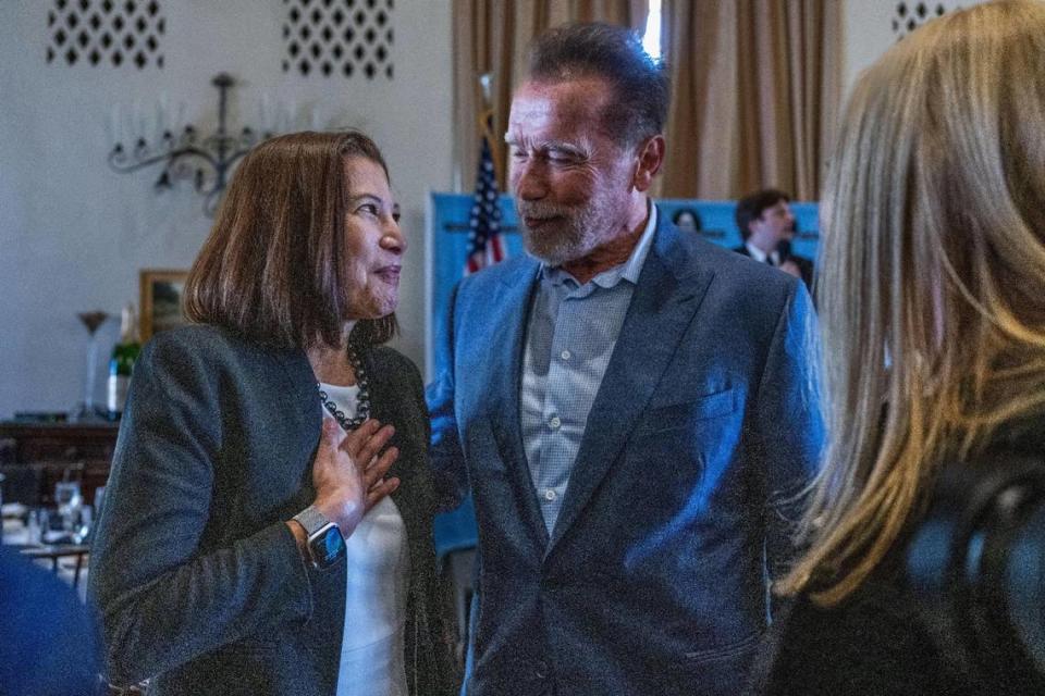 Retired California Supreme Court Chief Justice Tani Cantil-Sakauye talks Friday with former Gov. Arnold Schwarzenegger, who spoke at the Sacramento Press Club luncheon on the 20th anniversary of his inauguration. Cantil-Sakauye, who was appointed by Schwarzenegger, expressed her gratitude.