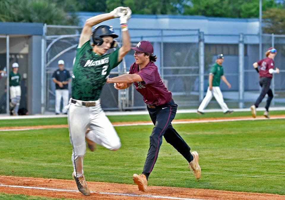 Lakewood Ranch's Clayton Dees is tagged out by Riverview's Pip Smalley during Wednesday night's game.