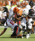 AUSTIN, TX - NOVEMBER 5: Running back Fozzy Whittaker #2 of the Texas Longhorns gets upended in the third quarter by D. J. Johnson #12 of the Texas Tech Red Raiders on November 5, 2011 at Darrell K. Royal-Texas Memorial Stadium in Austin, Texas. Texas beat Texas Tech 52-20. (Photo by Erich Schlegel/Getty Images)