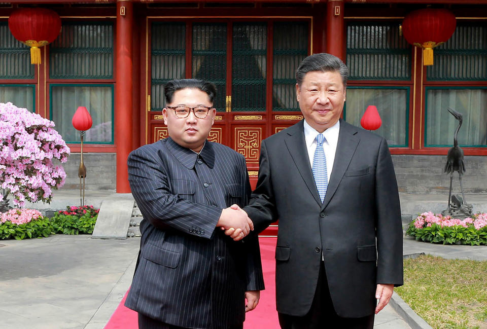 FILE - North Korean leader Kim Jong Un, left, shakes hands with Chinese counterpart Xi Jinping at Diaoyutai State Guesthouse in Beijing on March 27, 2018. The content of this image is as provided and cannot be independently verified. Since assuming power 10 years ago, North Korean leader Kim Jong Un has ruled the isolated country with absolute power, significantly expanded its nuclear arsenal and become the North’s first ruler to hold a summit with a sitting U.S. president. But now, he’s hunkering down and struggling to revive a dilapidated economy battered hard by pandemic-related border shutdowns, toughened U.N. sanctions and mismanagement. (Korean Central News Agency/Korea News Service via AP, File)