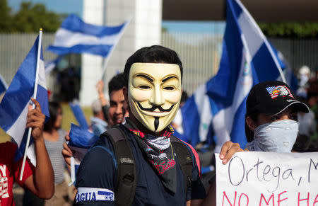 A protester wearing a Guy Fawkes mask takes part in a protest against Nicaraguan President Daniel Ortega's government in Managua, Nicaragua May 16, 2018. REUTERS/Oswaldo Rivas