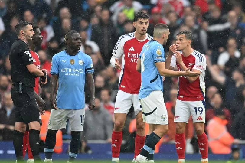 Leandro Trossard of Arsenal argues with Mateo Kovacic of Manchester City after being shown a red card during the Premier League match between City and Arsenal