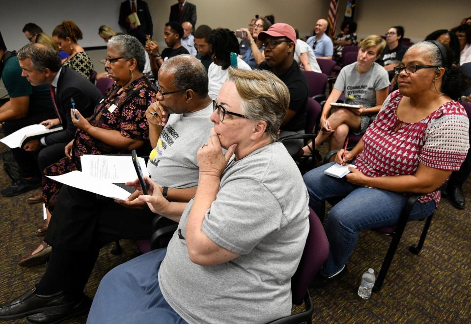Members of Community Oversight Now listen during the Davidson County Election Commission meeting Wednesday, Aug. 15, 2018, in Nashville. The election commission voted 5-0 to verify 4,801 petition signatures to add a proposed Metro Charter amendment creating a police oversight board to the Nov. 6 ballot.
