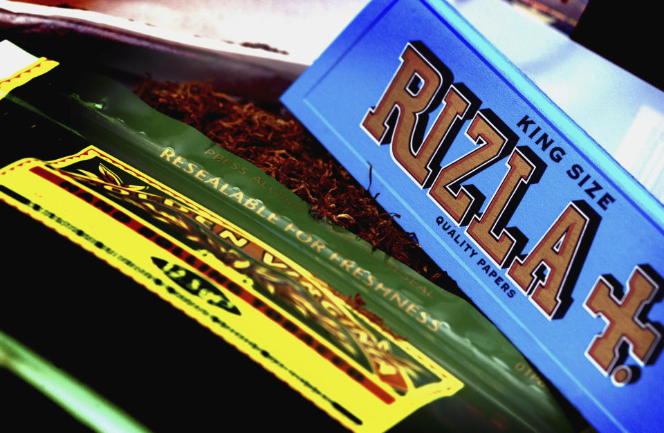 Picture shows A packet of Rizla Blue cigarette papers and a pouch of Golden Virginia tobacco. (Photo by: Newscast/Universal Images Group via Getty Images)