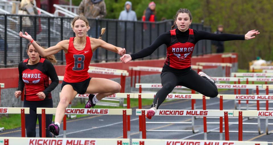 Bedford's Gabriella Pisanti and Olivia Harmon of Monroe battle for the lead in the high hurdles Tuesday.
