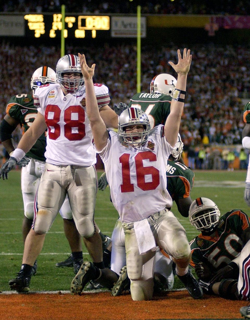 This photo ran in the EARLY EDITION of the special wraparound section -- 2003 Fiesta Bowl -- Ohio State's Craig Krenzel (16) celebrates his touchdown against Miami to tie the game and send it into a second overtime in the Fiesta Bowl in Tempe, Ariz., Friday, Jan. 3, 2003. Ohio State's Ben Hartsock (88) looks on at left. (AP Photo/Mark J. Terrill)