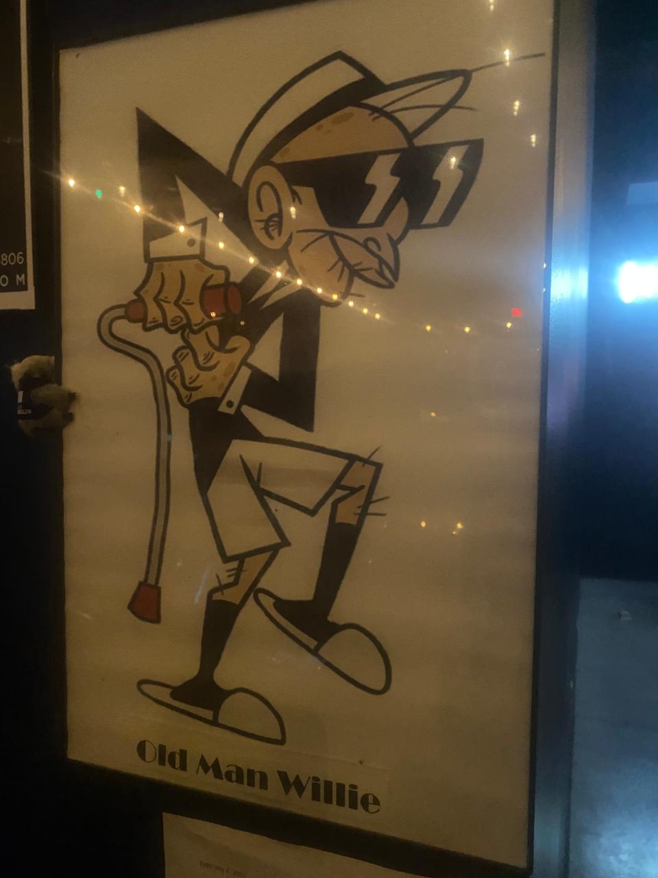 A caricature of "Old Man Willy" hangs near the bar of Blue Room Comedy Club.