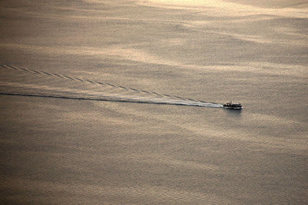 FILE PHOTO -- A waterman, a commercial fisherman who traditionally harvests crabs in the summer and oysters in the winter, works his way across the Chesapeake Bay in Maryland, U.S. February 1, 2017. REUTERS/Jonathan Ernst