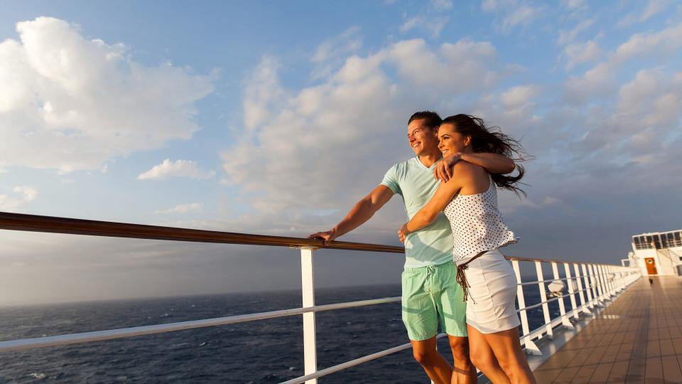 couple standing on cruise deck