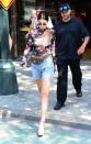 <p>Kendall showed off her girly side in a subtly sheer rose-printed top and midi denim shorts.</p>