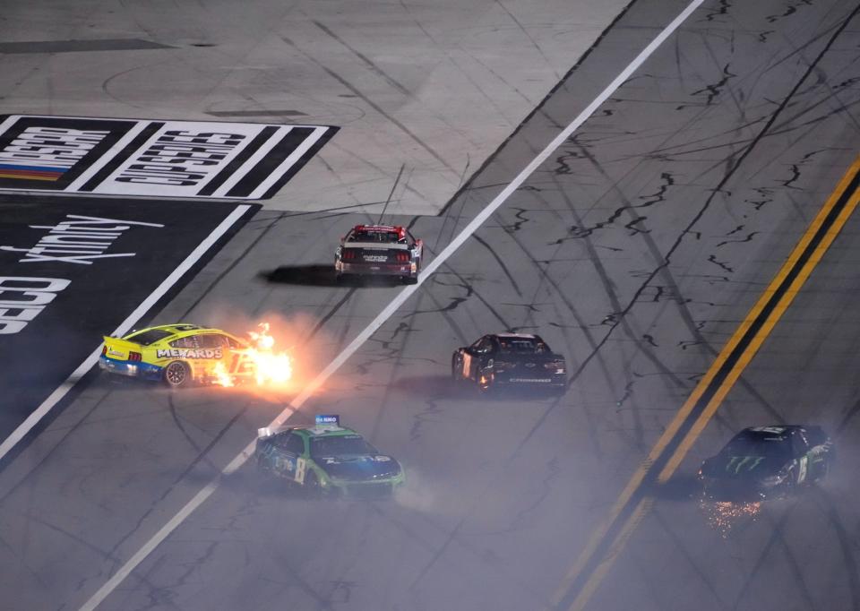 Ryan Blaney's car (12) bursts into flames as a massive crash late in the second Daytona Duel brings out the red flag.