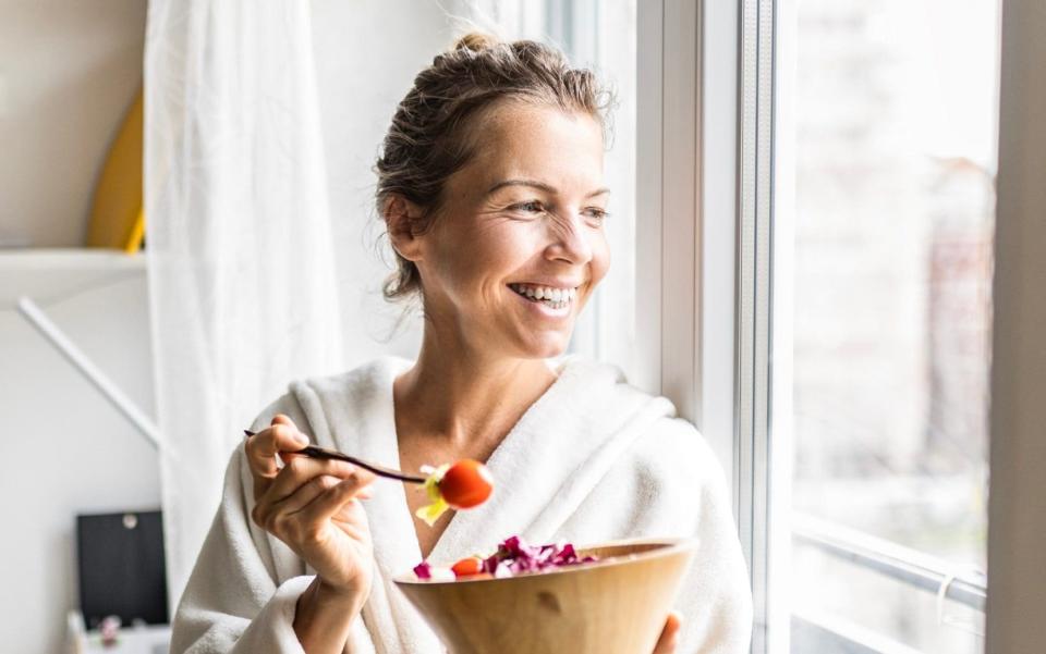 woman eating salad - Getty