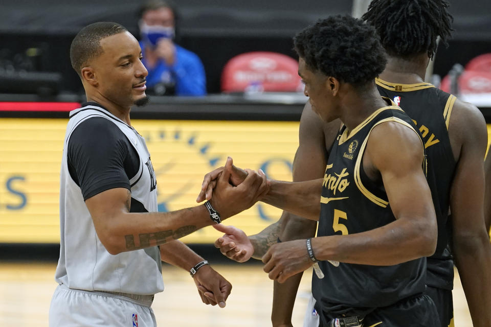 Portland Trail Blazers forward Norman Powell shakes hands with Toronto Raptors forward Stanley Johnson (5) after an NBA basketball game Sunday, March 28, 2021, in Tampa, Fla. (AP Photo/Chris O'Meara)