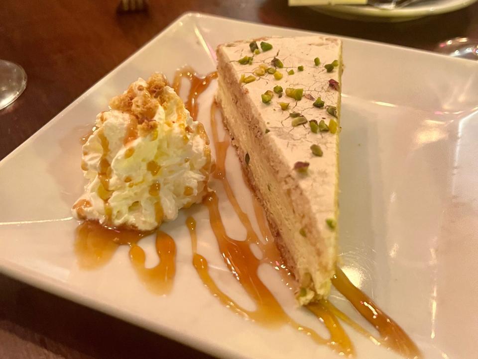 The dessert was a pistachio cake with whipped cream and caramel.