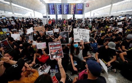 Anti-extradition bill demonstrators attend a protest at the departure hall of Hong Kong Airport