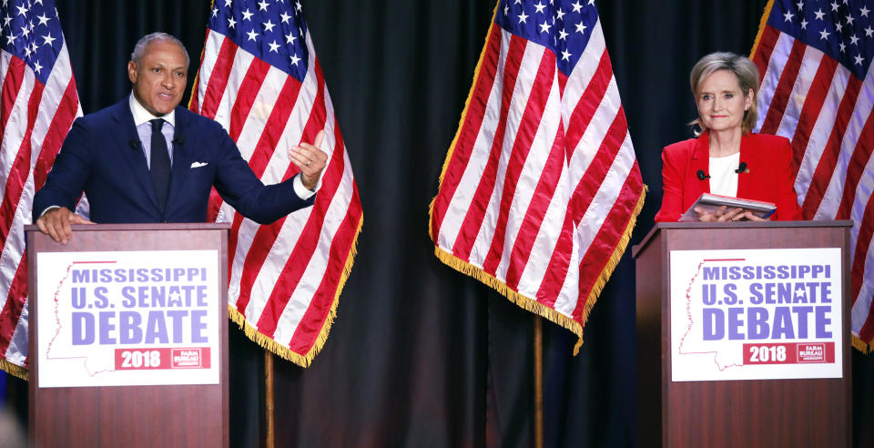 FILE - In this Nov. 20, 2018, file photo, Democrat Mike Espy, left, challenges an answer from appointed U.S. Sen. Cindy Hyde-Smith, R-Miss., during their televised Mississippi U.S. Senate debate in Jackson, Miss. Hyde-Smith faces Espy, a former congressman and former U.S. agriculture secretary, in a runoff election Tuesday, Nov. 27. The winner gets the final two years of a six-year term. (AP Photo/Rogelio V. Solis, Pool, File)