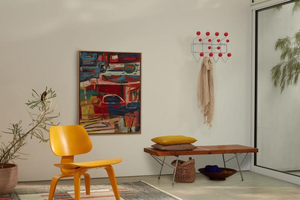 Herman Miller’s Molded Plywood lounge chair and Hang-It-All in Stonewash Blue Red by Charles and Ray Eames 