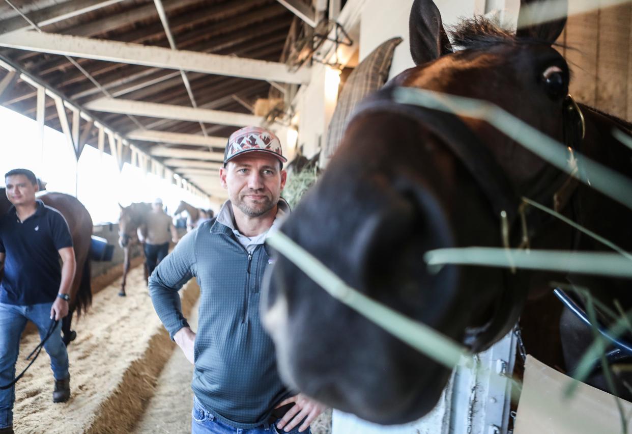 Kentucky Derby hopeful Honor Marie peeks around his stall as trainer Whit Beckman stands by. Beckman is a Louisville native and St. Xavier graduate.