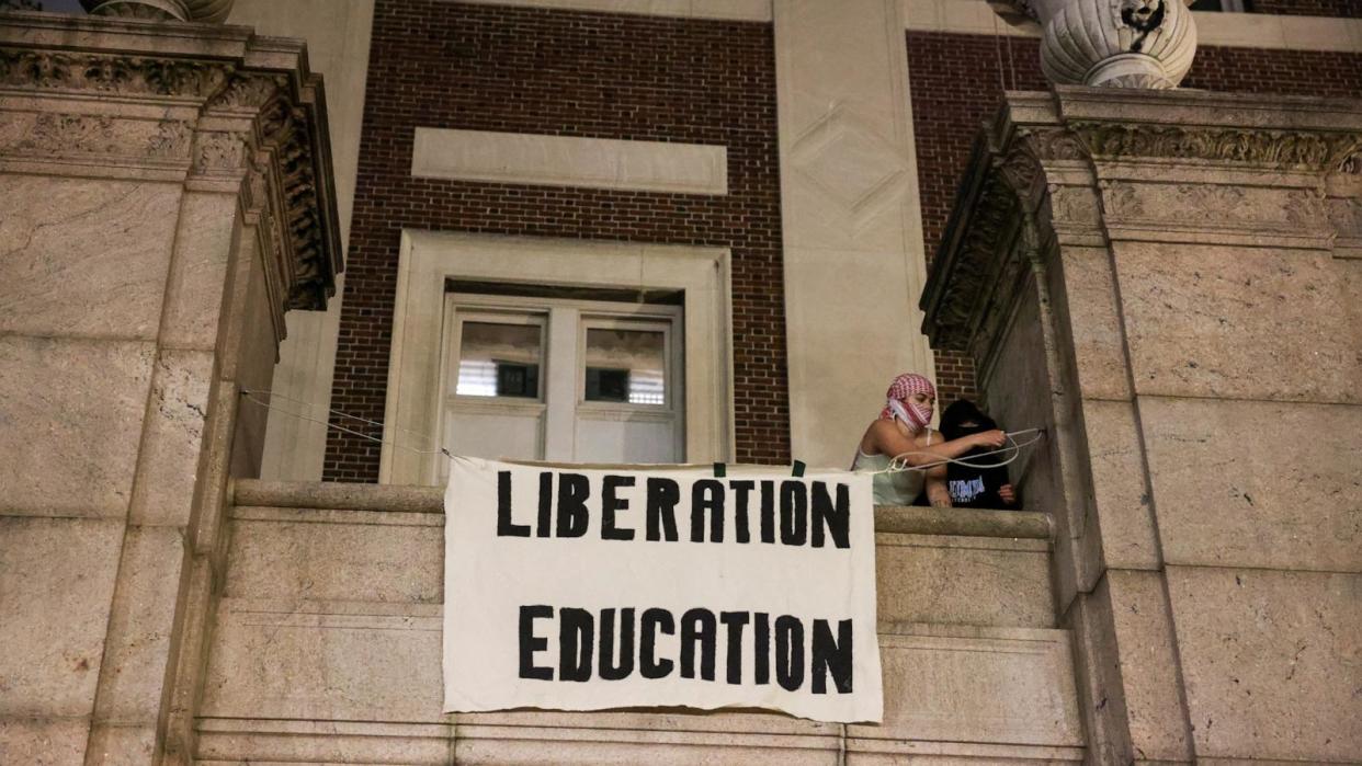 PHOTO: Protesters hang banners on the exterior of Hamilton Hall building after barricading themselves inside the building at Columbia University in New York City, April 30, 2024. (Caitlin Ochs/Reuters)