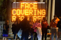 A sign encourages visitors to wear face masks amid the COVID-19 pandemic Friday, Feb. 19, 2021, in Santa Monica, Calif. (AP Photo/Marcio Jose Sanchez)