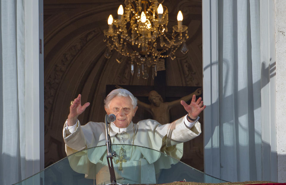 FILE - Pope Benedict XVI waves from the balcony window of the Pontifical summer residence in Castel Gandolfo outside of Rome, to a cheering crowd gathered to see him on Feb. 28, 2013, the day he ended his pontificate. In an interview with The Associated Press Tuesday, Jan. 24, 2023, Pope Francis said he hasn't even considered issuing norms to regulate future papal resignations and says he plans to continue on for as long as he can as bishop of Rome, despite a wave of attacks against him by some top-ranked cardinals and bishops. (AP Photo/Domenico Stinellis, File)