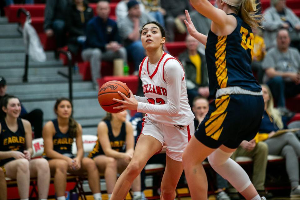 Holland's Ariana Gray drives to the basket past her Hudsonville defender Wednesday, March 2, 2022, at Holland High School. 