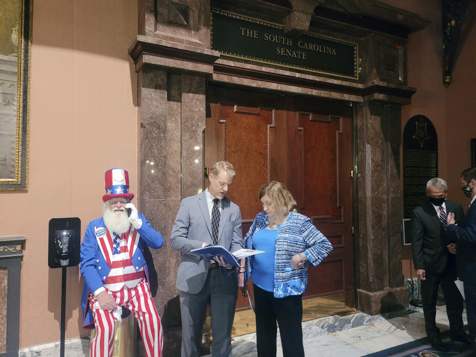 A man dressed as Uncle Sam sits outside the South Carolina Senate chamber as senators debate a proposal that would add South Carolina to a list of states calling for a U.S. constitutional convention to consider term limits and a balanced budget requirement watch the state Senate debate on Tuesday, March 8, 2022, in Columbia, S.C. (AP Photo/Jeffrey Collins)