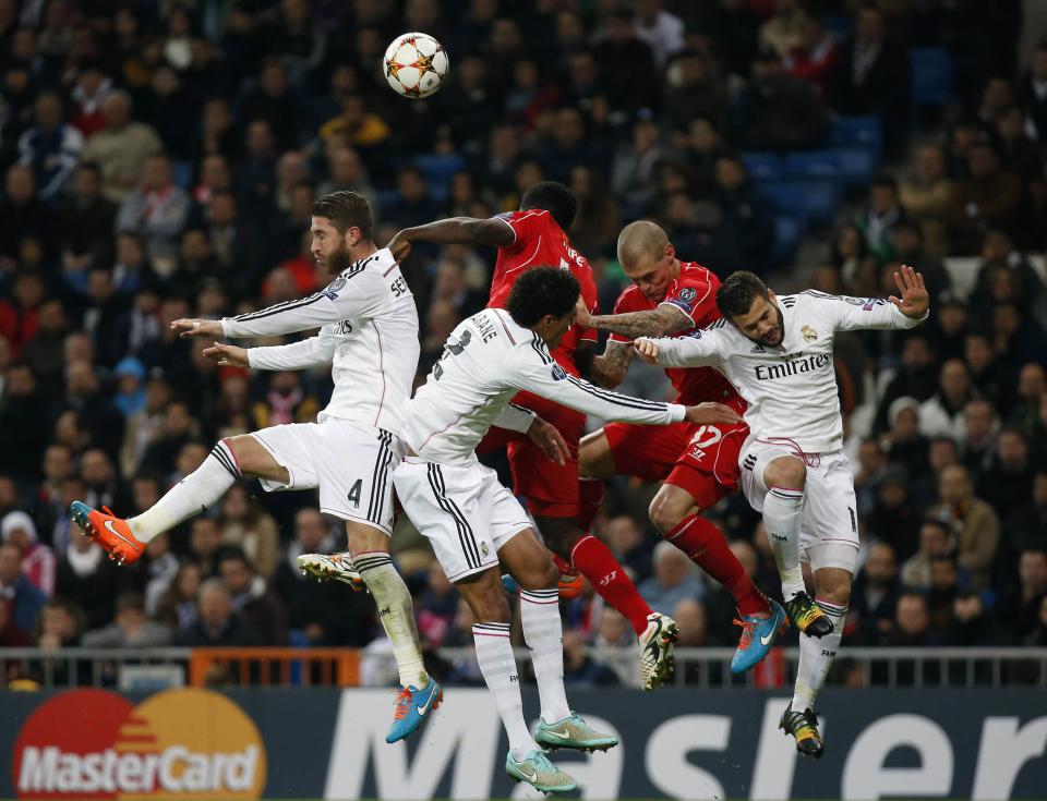 Liverpool and Real Madrid players jump for a ball during their Champions League Group B soccer match at Santiago Bernabeu stadium in Madrid, in this November 4, 2014 file photo. REUTERS/Susana Vera/Files (SPAIN - Tags: SPORT SOCCER TPX IMAGES OF THE DAY)