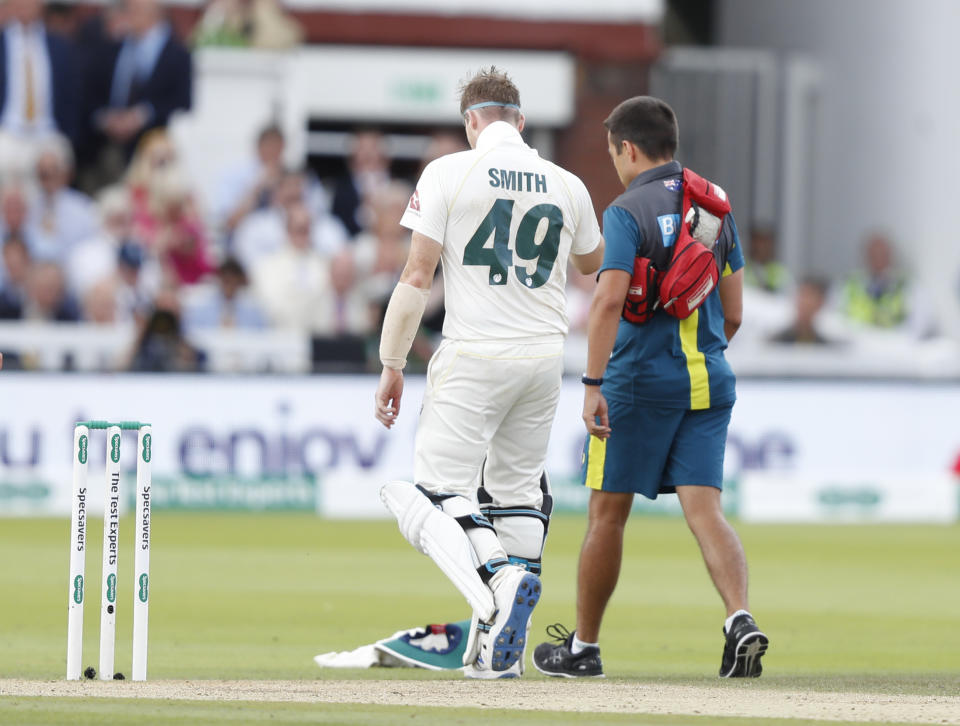 Australia's Steve Smith leaves the pitch injured after being hit by a ball bowled by England's Jofra Archer during play on day four of the 2nd Ashes Test cricket match between England and Australia at Lord's cricket ground in London, Saturday, Aug. 17, 2019. (AP Photo/Alastair Grant)