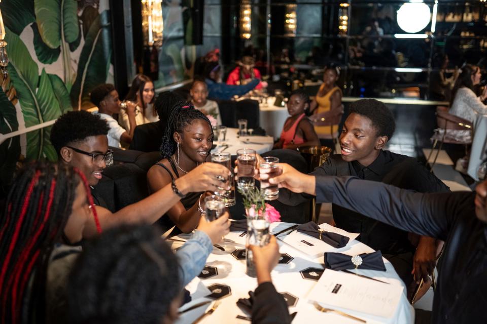 (Right to left) Tomlinson Middle School students Jeremiah, Chris, Ser'ryah and Tre' (last names withheld) do a toast while sitting down for a dinner with former Detroit Lions defensive tackle and motivational speaker Andre Fluellen at Prime + Proper Steakhouse in downtown Detroit on Monday, May 13, 2024. For the past three years Fluellen has been mentoring eighth grade students at the Inkster school along with Super Bowl Champion Lee Rouson, WNBA player Rushia Brown, and two time Olympic Gold Medalist Ruthie Bolton for the "Move Your Chains" mentorship program.