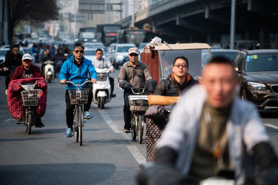 People pictured riding bikes in Beijing, China.