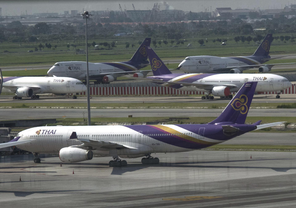 Thai Airways jets sit on the tarmac at the Suvarnabhumi Airport in Bangkok, Thailand, Monday, Sept. 14, 2020. Thailand's Central Bankruptcy Court on Monday gave the go-ahead to financially ailing Thai Airways International to submit a business reorganization plan and appointed seven planners to oversee it. (AP Photo/Sakchai Lalit)