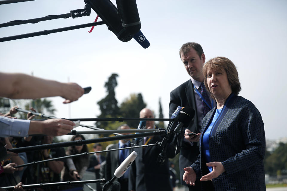 Vice President of the European Commission and High Representative of the Union for Foreign Affairs and security policy Catherine Ashton, right, speaks to the press as she arrives for an Informal meeting of Ministers For Foreign Affairs at Zappeion Hall in Athens, on Friday, April 4, 2014. European Union foreign ministers meeting in Athens on Friday urged Russia to take concrete steps to pull troops back from its border with Ukraine but said they wanted to keep communication with Moscow open.(AP Photo/Petros Giannakouris)