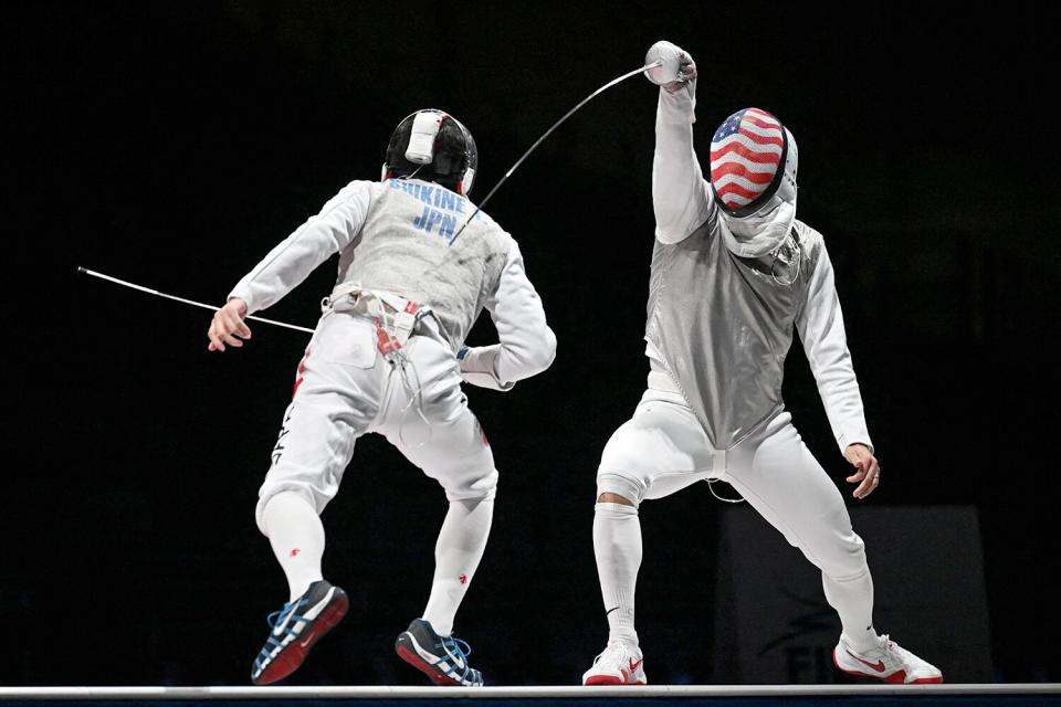 Japan's Takahiro Shikine (L) compete against USA's Gerek Meinhardt in the mens team foil bronze medal bout during the Tokyo 2020 Olympic Games at the Makuhari Messe Hall in Chiba City, Chiba Prefecture, Japan, on August 1, 2021.