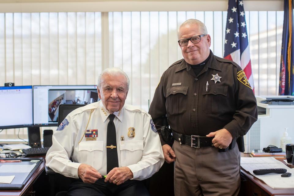 Warren Police Commissioner William Dwyer, left, in his office with his son Dave Dwyer who is an Oakland County Sheriff Deputy at the Christopher M. Wouters Police Headquarters in Warren on Wednesday, Dec. 13, 2023.