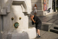 A man cools himself at a public fountain in Belgrade, Serbia, Friday, June 21, 2024. A major hourslong power outage hit much of the Balkans on Friday as the southern European region sweltered in an early heat wave that sent temperatures soaring to more than 40 C (104 F). (AP Photo/Darko Bandic)