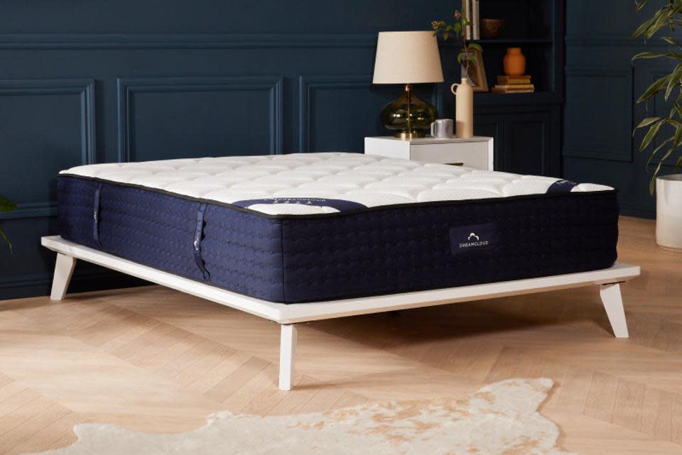  When to replace your mattress: mattress on a base in the middle of a room. 