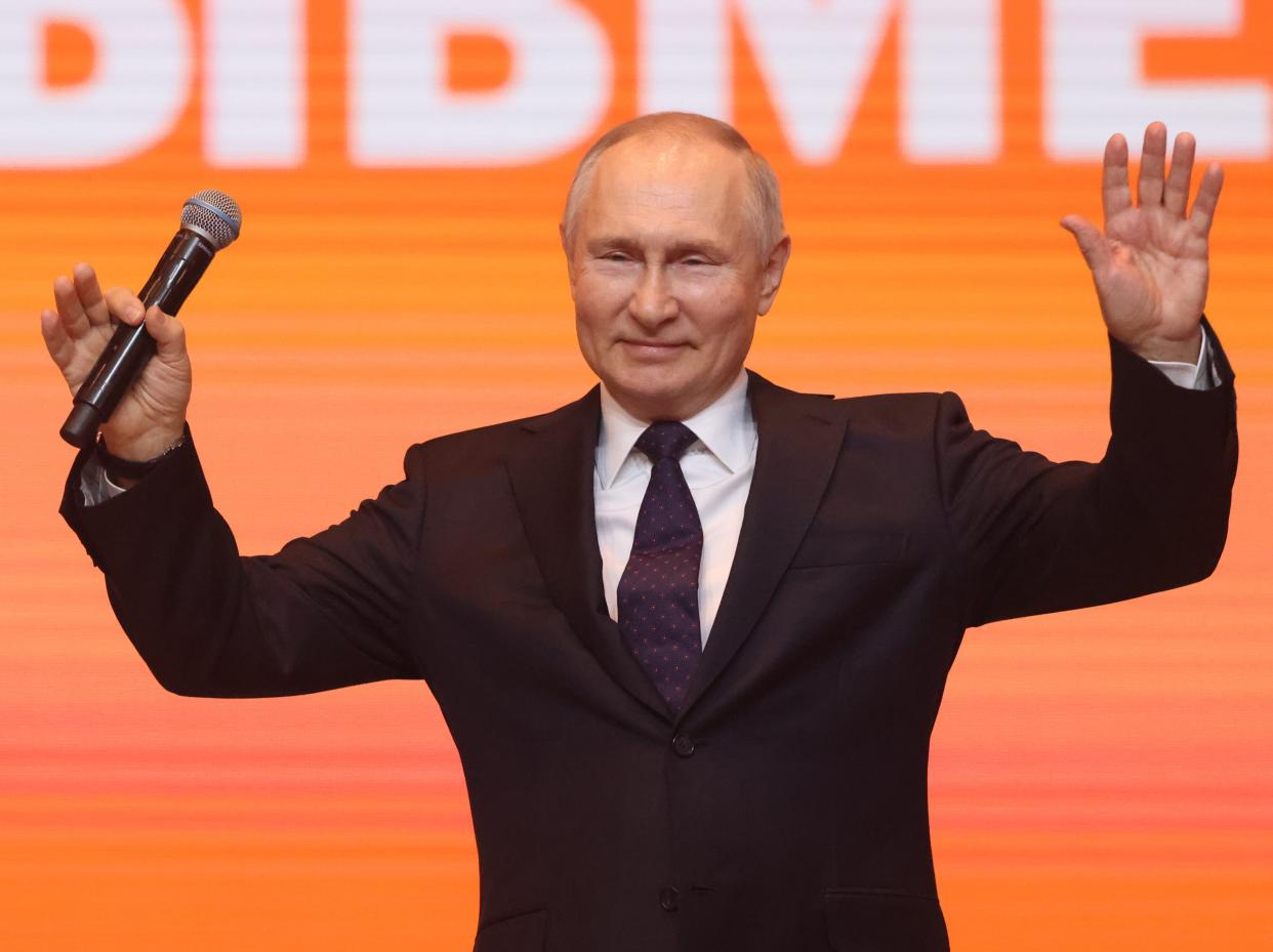 Russian President Vladimir Putin waves during the awarding ceremony at the We Are Toghether Youth Forum, on December 5, 2022 in Moscow, Russia. President Putin visited a youth forum, hosted by State Agency for Youth Affairs.