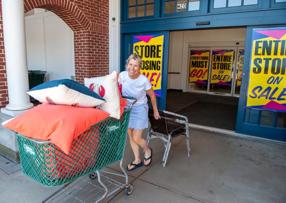 Bee Loprete, of Concord, exits the liquidation sale under way at the Christmas Tree Shops in Sherwood Plaza in Natick, July 7, 2023.