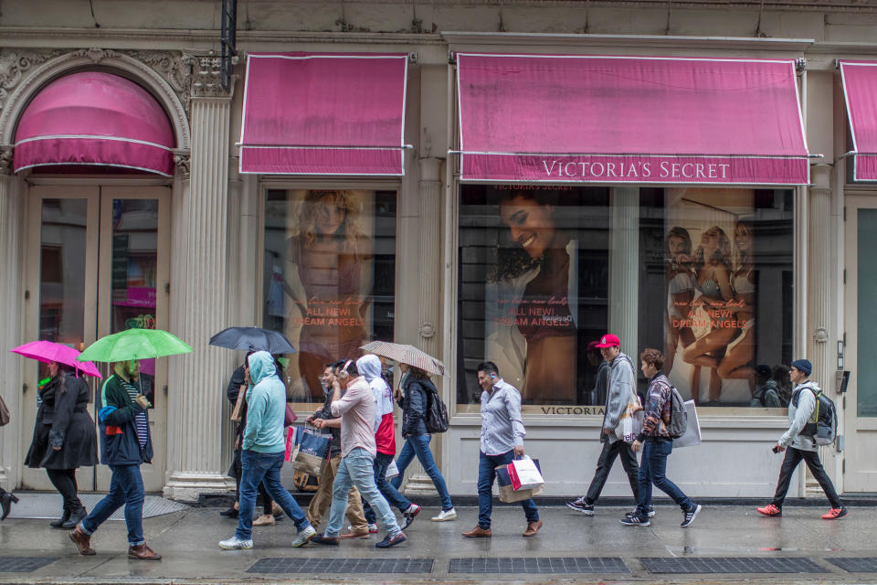 FILE- In this April 4, 2018, file photo, shoppers walk past the Victoria's Secret store on Broadway in the Soho neighborhood of New York. Shares in the company that owns Victoria Secret and Bath & Body Works are surging after a hedge fund began pushing for a sale or turning the latter into a separate, publicly traded company. Barington Capital Group laid out those recommendations and others in a letter Tuesday, March 5, 2019, to L Brands CEO Leslie Wexner. (AP Photo/Mary Altaffer, File)