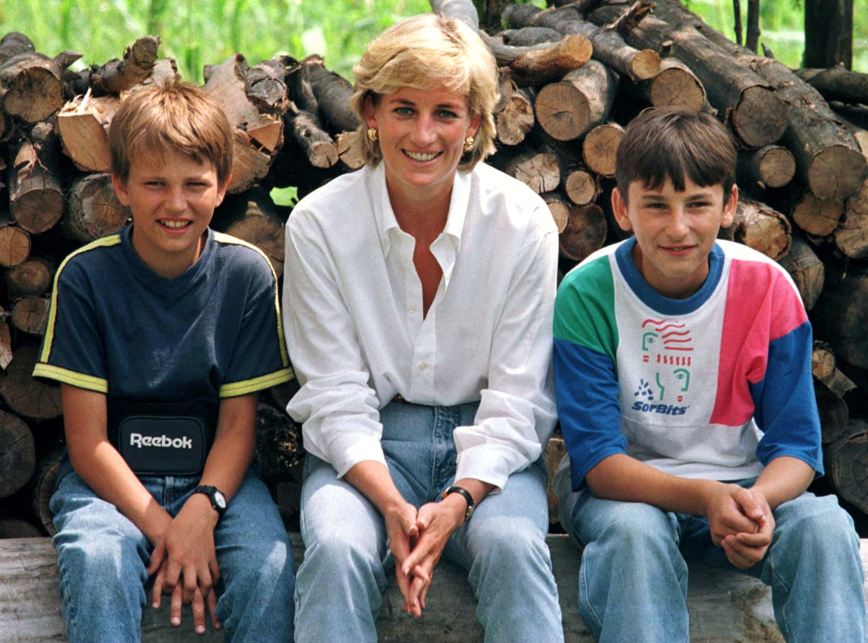 Diana, Princess of Wales sits with mine victim, Malic Bradoric, 14, (R) who is a Muslim, and fellow mine victim Zarco Beric, 12, a Serb during Diana's visit to Bosnia and Herzegovina August 9. Diana is in Bosnia and Herzegovina until Sunday.