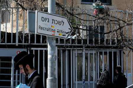 An Ultra-Orthodox Jewish man walks past the entrance to the Israeli military recruiting office in Jerusalem, March 13, 2018. REUTERS/Ronen Zvulun